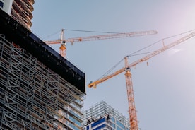 yellow crane near building during daytime
