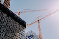 yellow crane near building during daytime