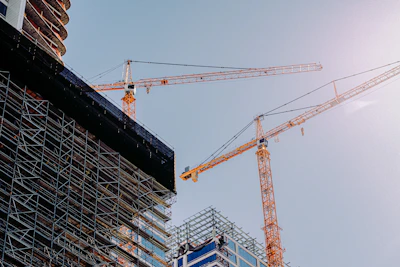 yellow crane near building during daytime