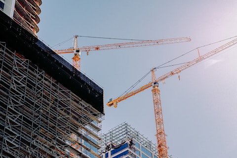 yellow crane near building during daytime