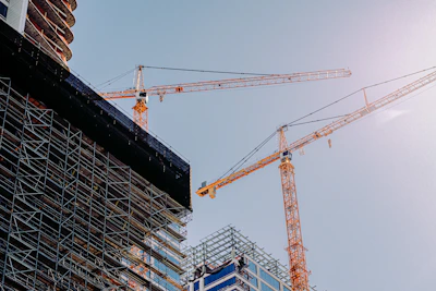 yellow crane near building during daytime