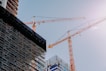 yellow crane near building during daytime