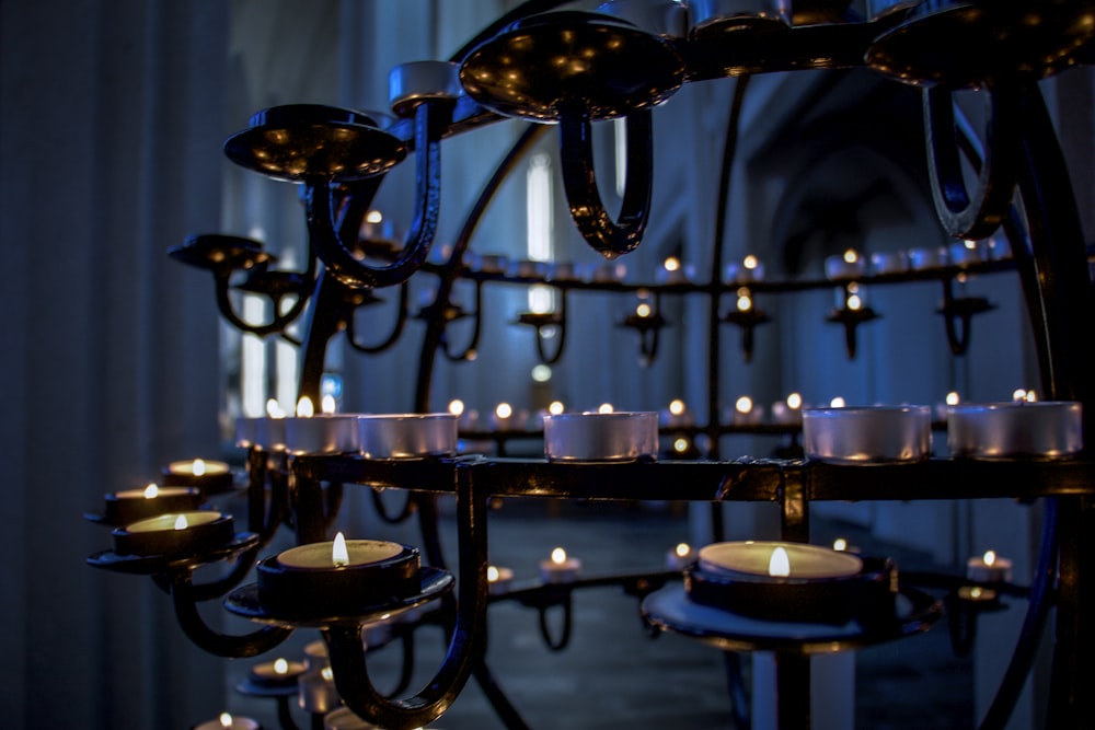 lighted candles on black metal candle holder