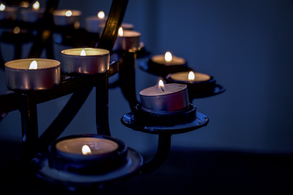 lighted candles on black metal candle holder