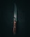 A sharp kitchen knife with a wooden handle lies against a dark, textured background. The blade reflects a subtle sheen, casting faint shadows and highlighting its polished surface. Three small metal rivets secure the handle, contributing to its sturdy appearance.