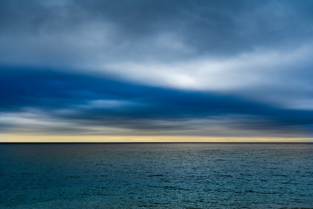 blue sea under blue and white cloudy sky during daytime