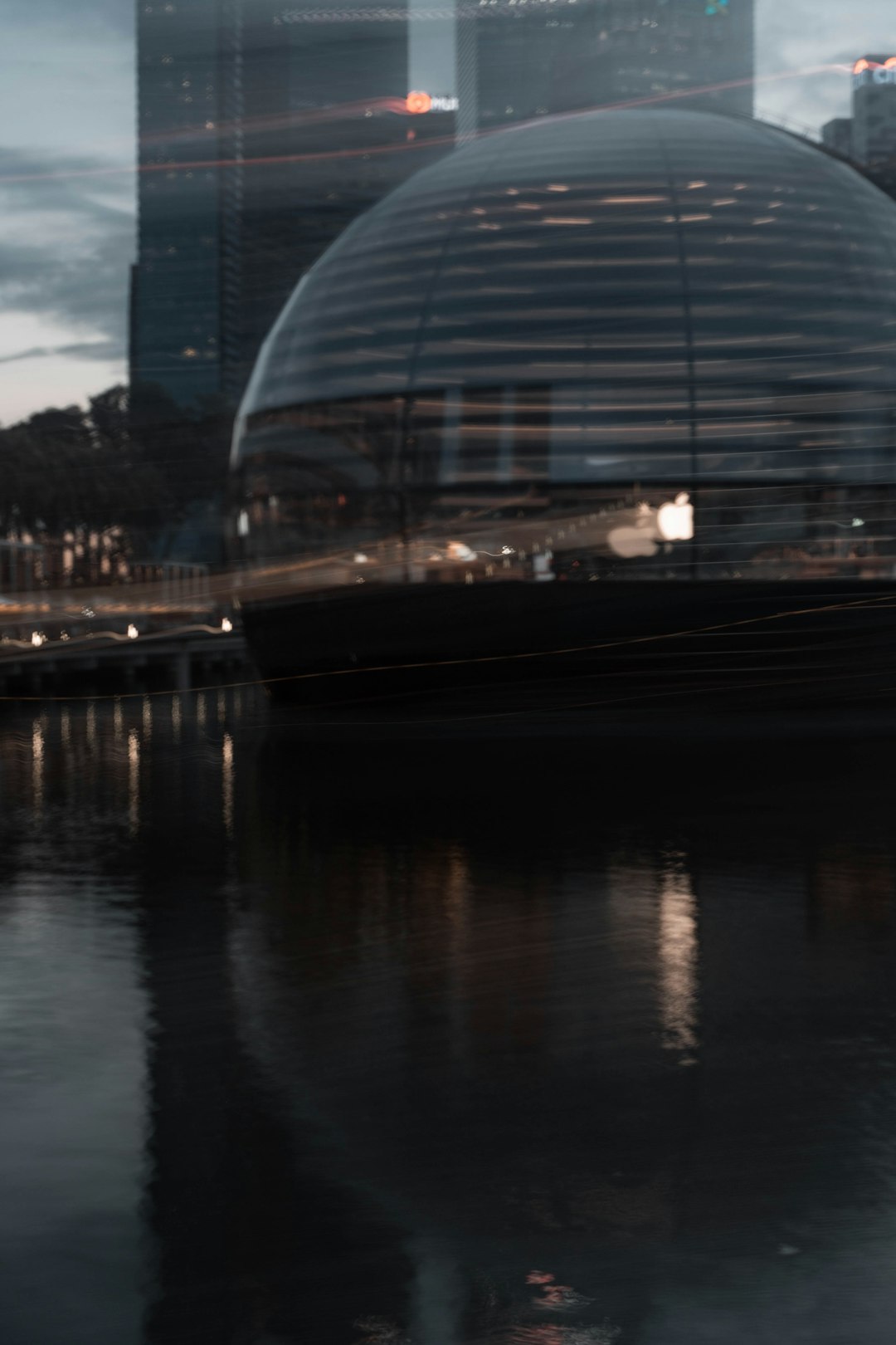 glass building near body of water during night time