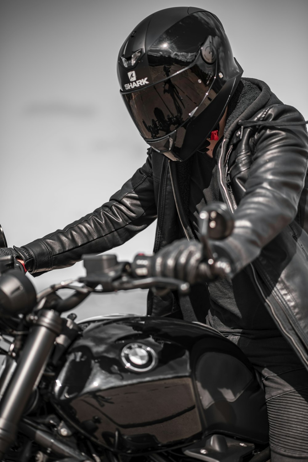 man in black leather jacket riding on motorcycle