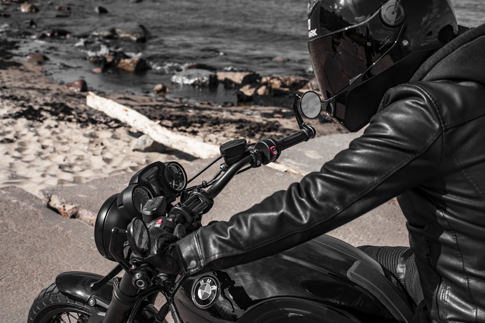 man in black leather jacket riding motorcycle during daytime