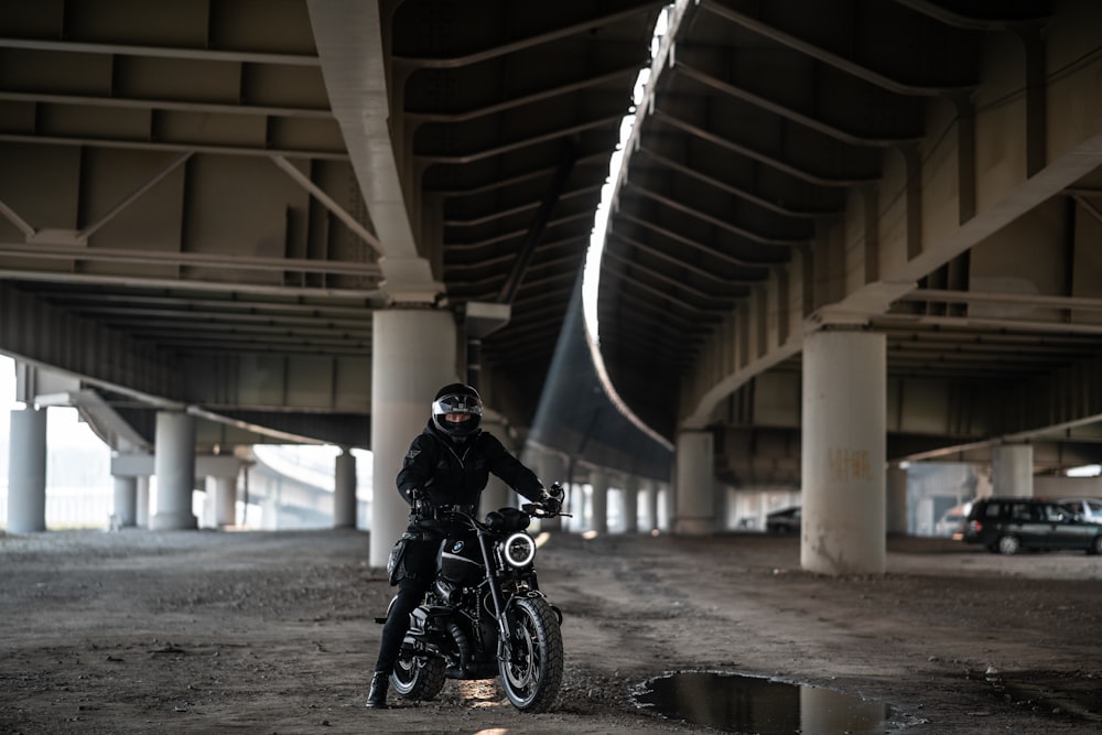 man in black jacket riding black motorcycle