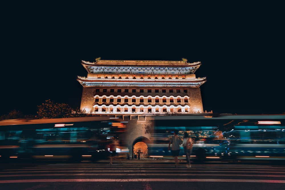 people walking on street near building during night time