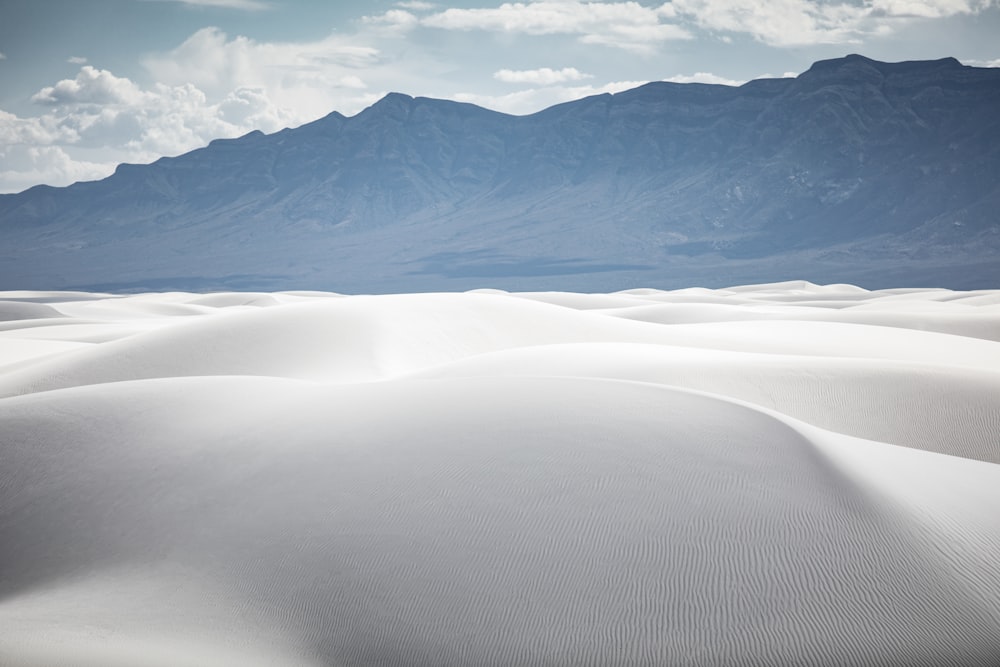 white sand and mountains during daytime