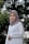 woman in white hijab standing near green trees during daytime