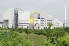white and yellow building near green grass field during daytime