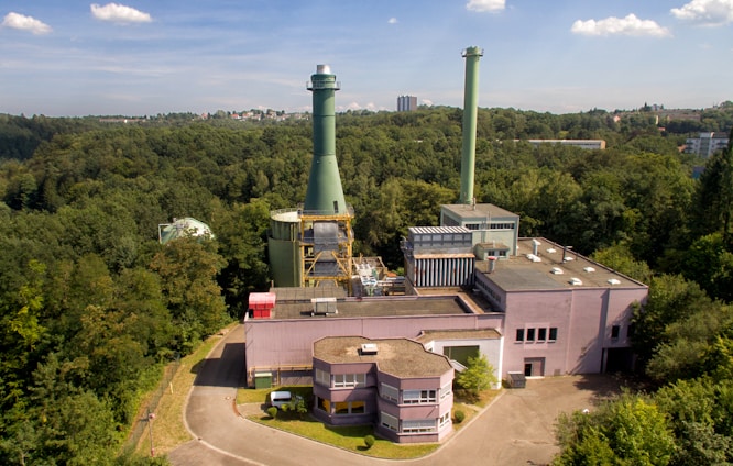 A modern industrial facility in Belgrade with large pyrolysis equipment under operation against a clear blue sky.