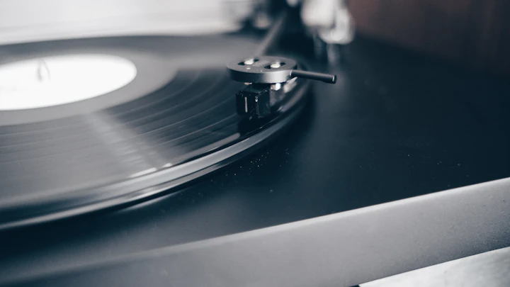Black vinyl record resting on a black tabletop