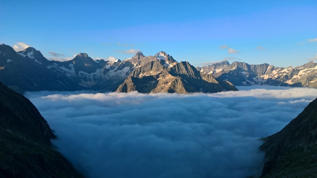 snow covered mountains under blue sky during daytime