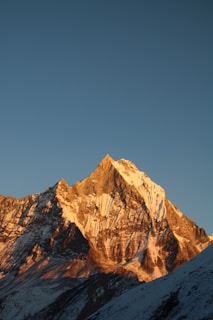 A peaceful mountain peak bathed in golden light, symbolizing clarity.