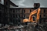 yellow excavator near brown concrete building during daytime