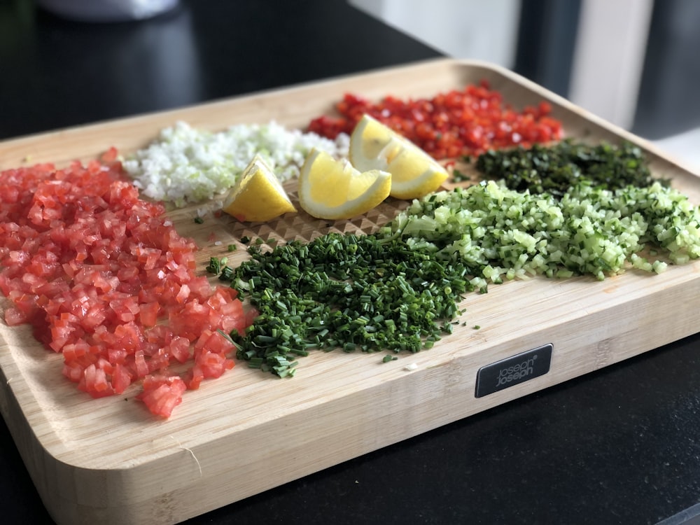 green vegetable and red sauce on brown wooden tray