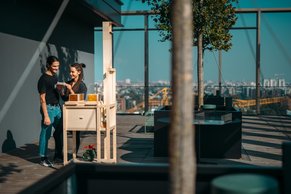 man and woman sitting on bench near body of water during daytime