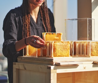 man in brown and black plaid dress shirt holding yellow and white cake