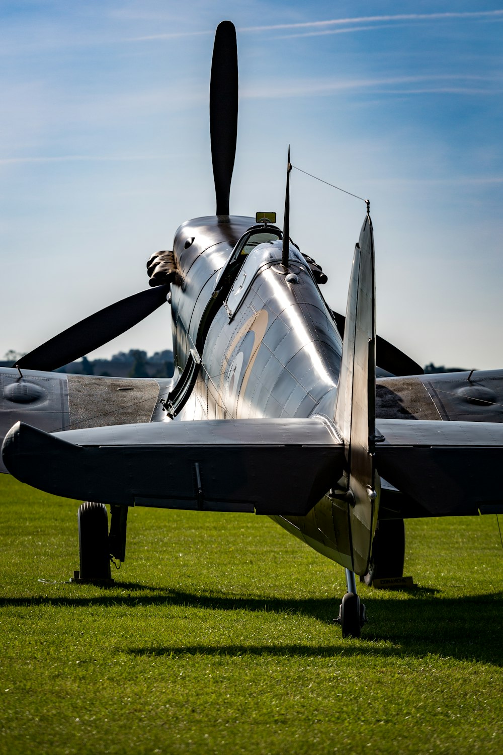 black fighter jet on green grass field during daytime