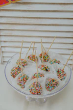 Close-up of labeled artisanal cake pops indicating compliance with cottage food regulations.
