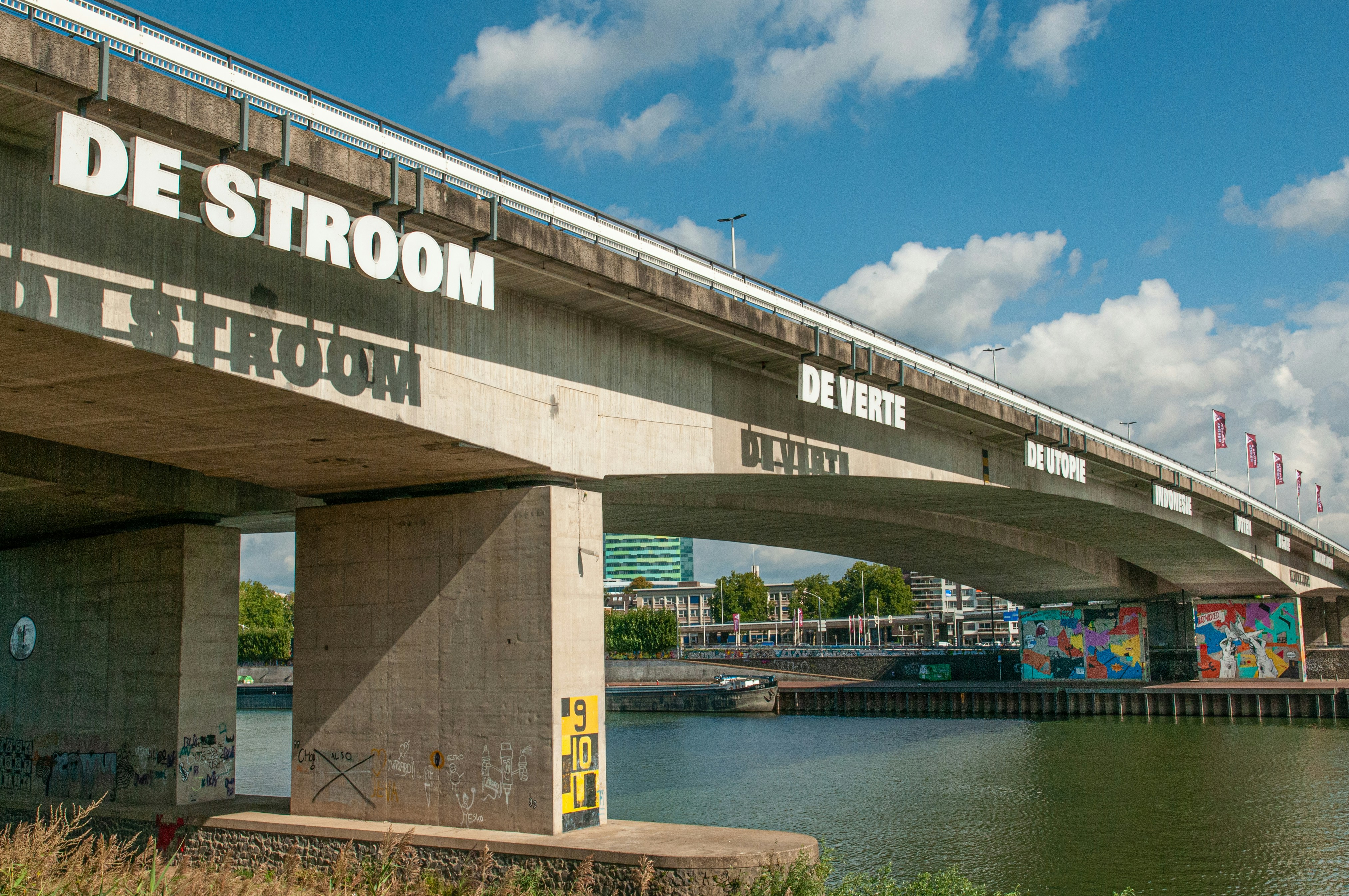 brown and white bridge over river under blue sky during daytime