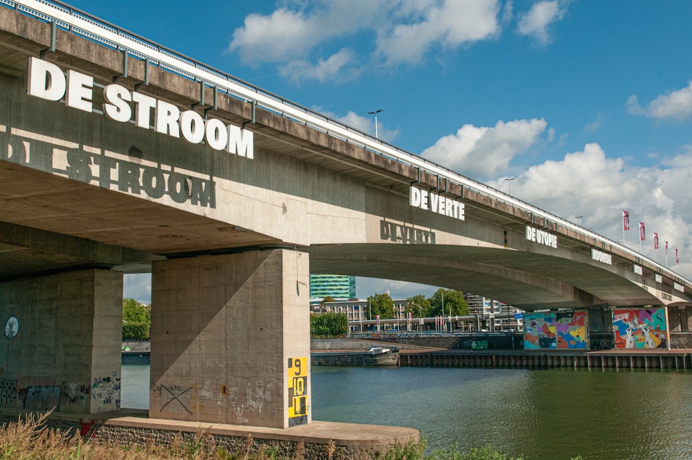 brown and white bridge over river under blue sky during daytime