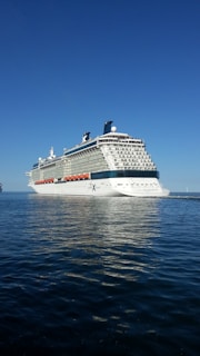 A luxurious MSC cruise ship sailing through clear blue Caribbean waters.