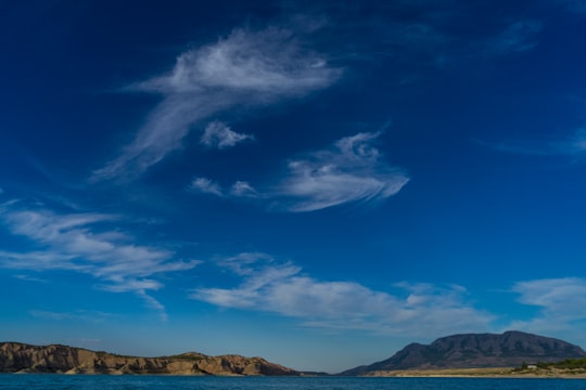 brown mountains under blue sky and white clouds during daytime in Negratín Reservoir Spain