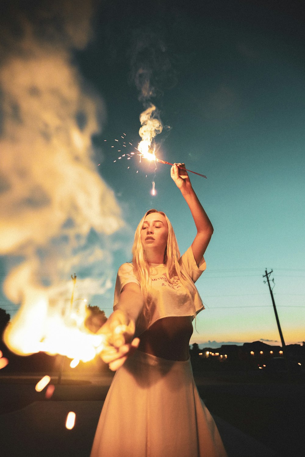 woman in white crop top holding sparkler