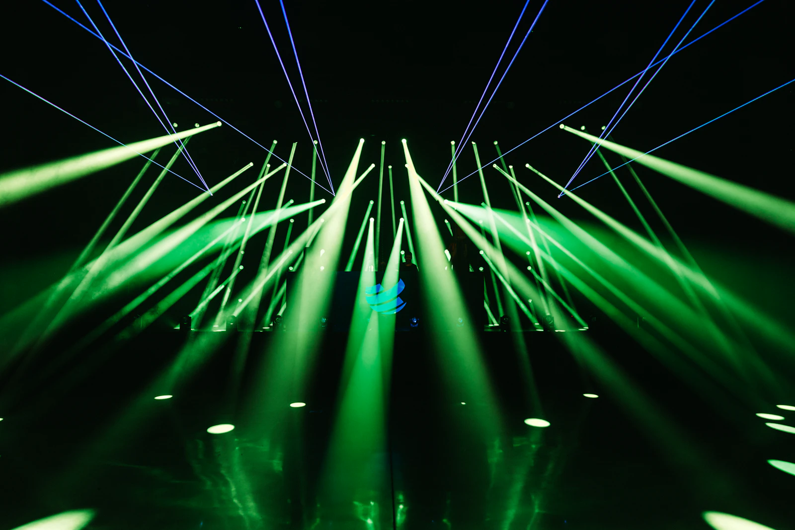 Green laser beams cutting through darkness (illustrative)