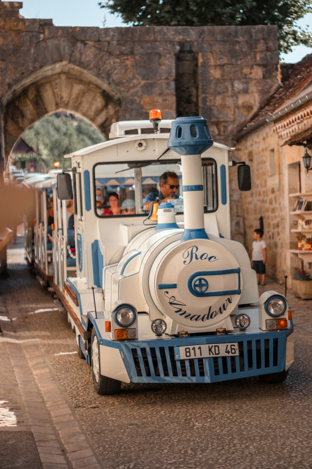 white and blue volkswagen t-2 van on road during daytime