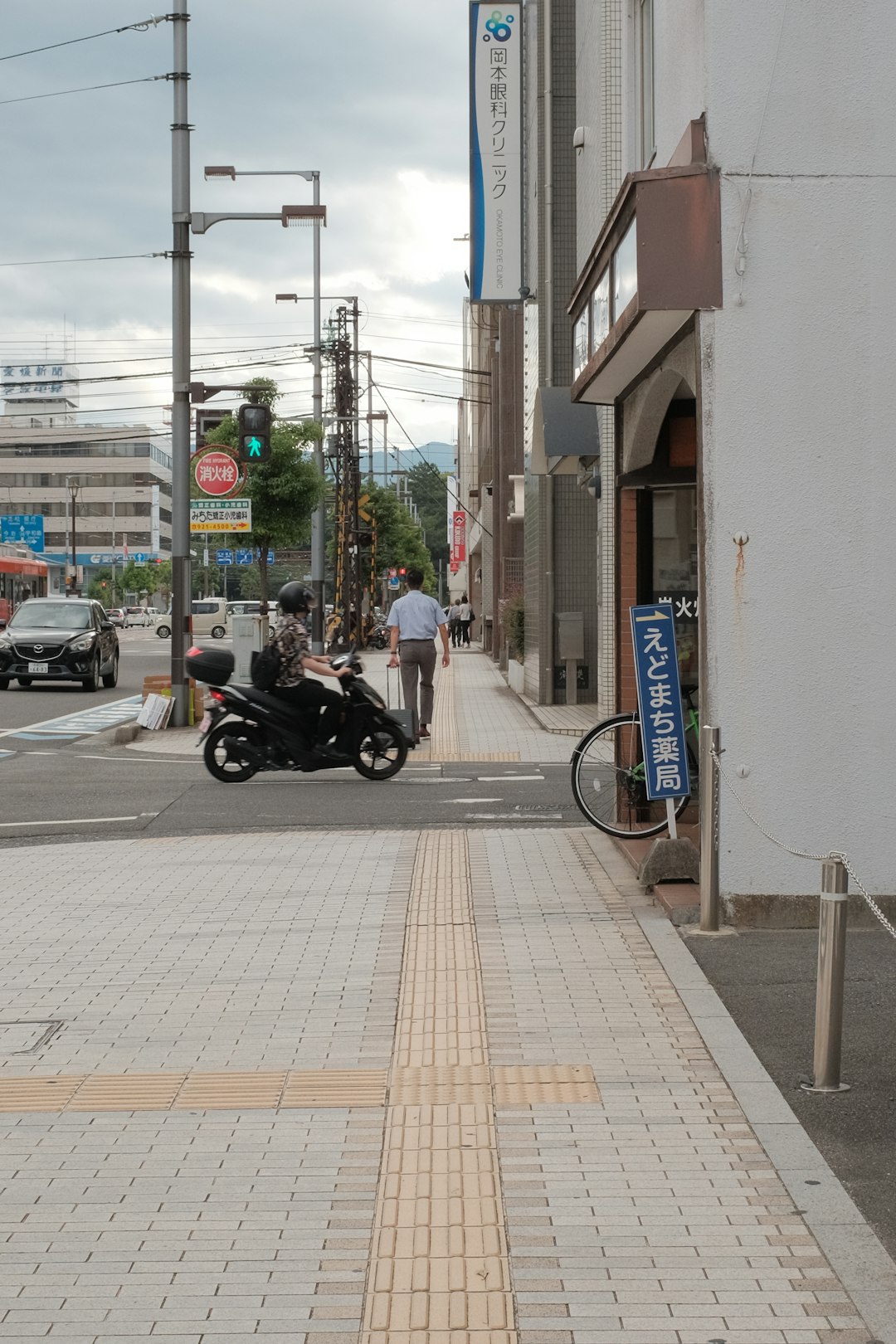 black motorcycle parked on sidewalk during daytime