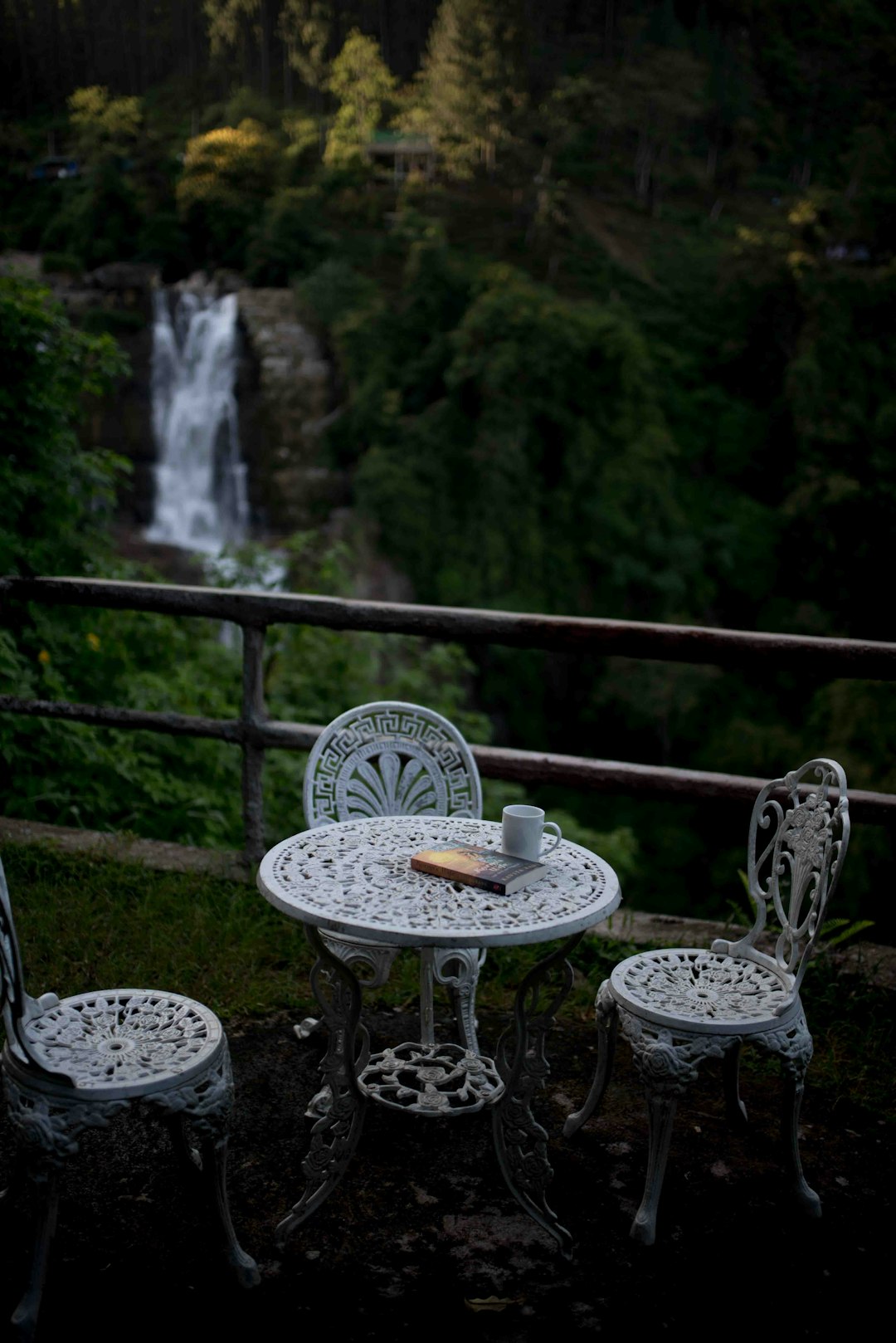 white metal chairs on black metal railings