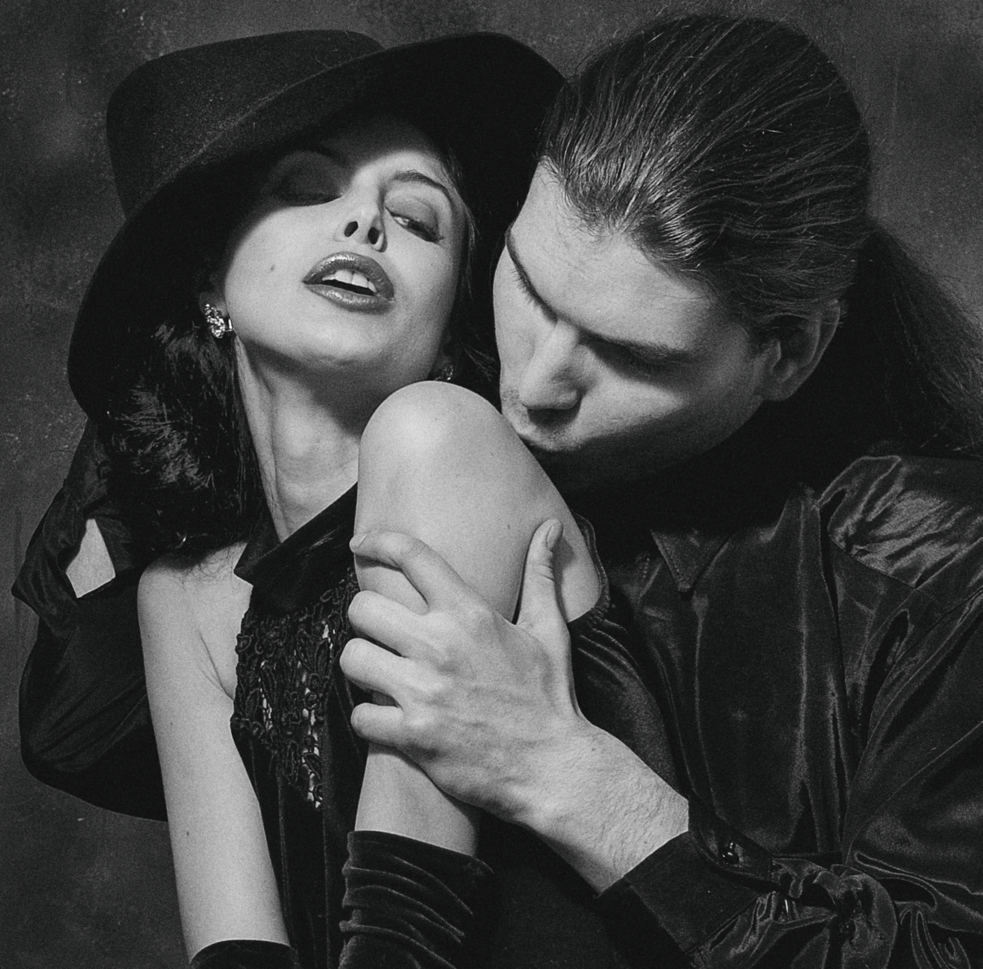 man and woman kissing grayscale photo