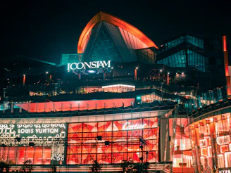 a large building with a lit up sign on top of it