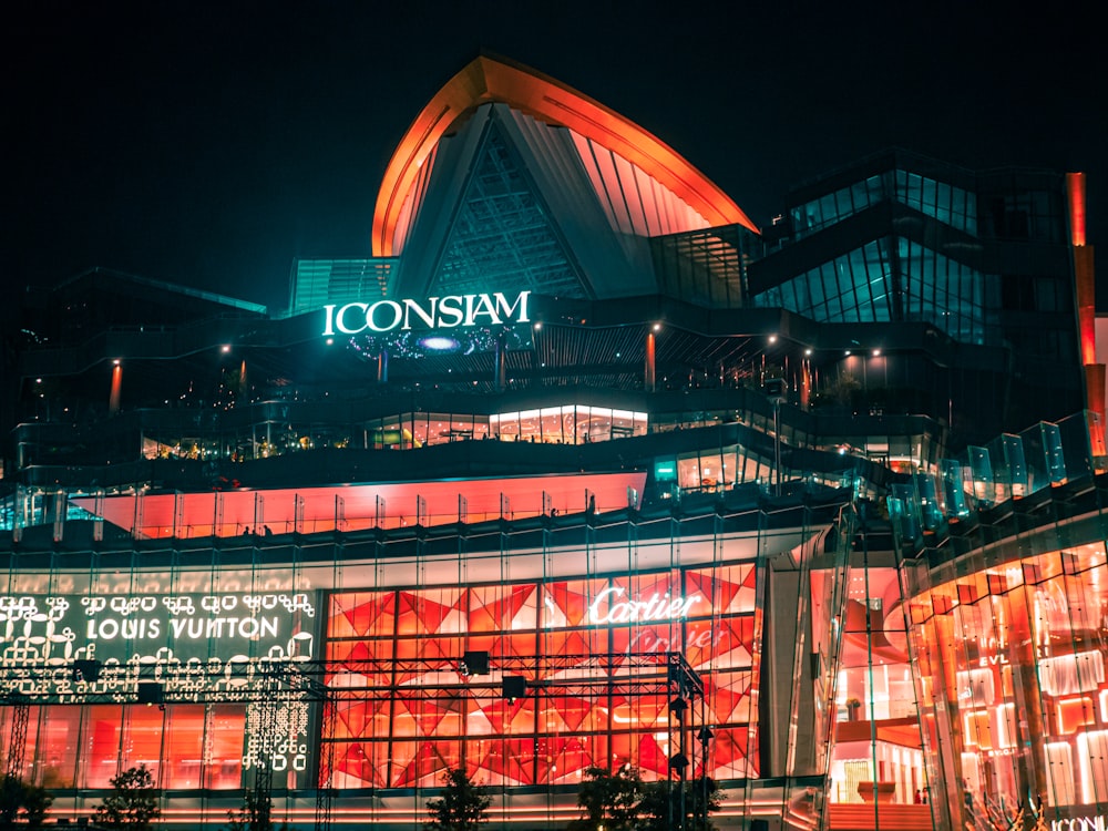 a large building with a lit up sign on top of it