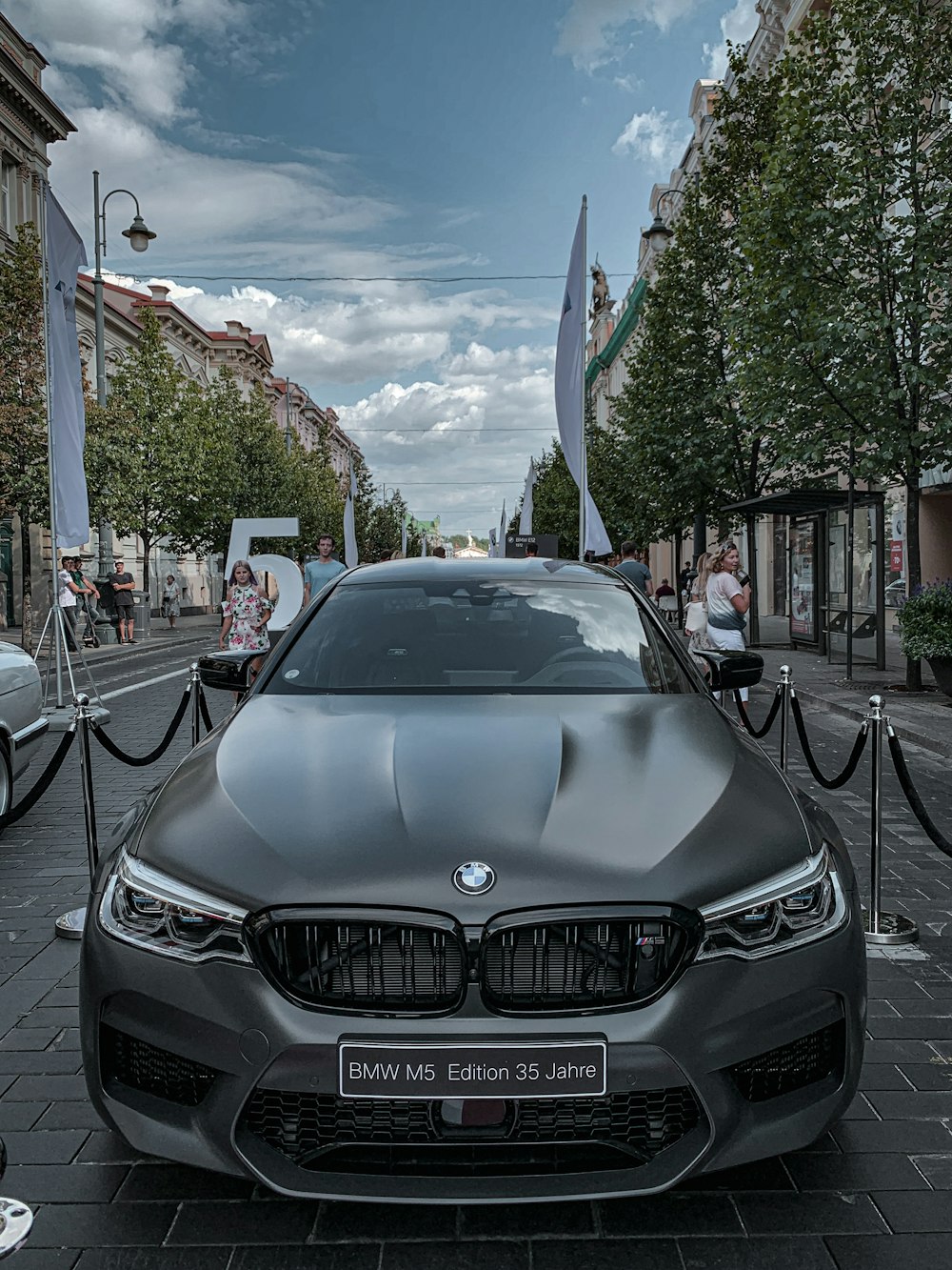 black bmw car parked on sidewalk during daytime