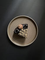 brown and black dog figurine on white ceramic round plate