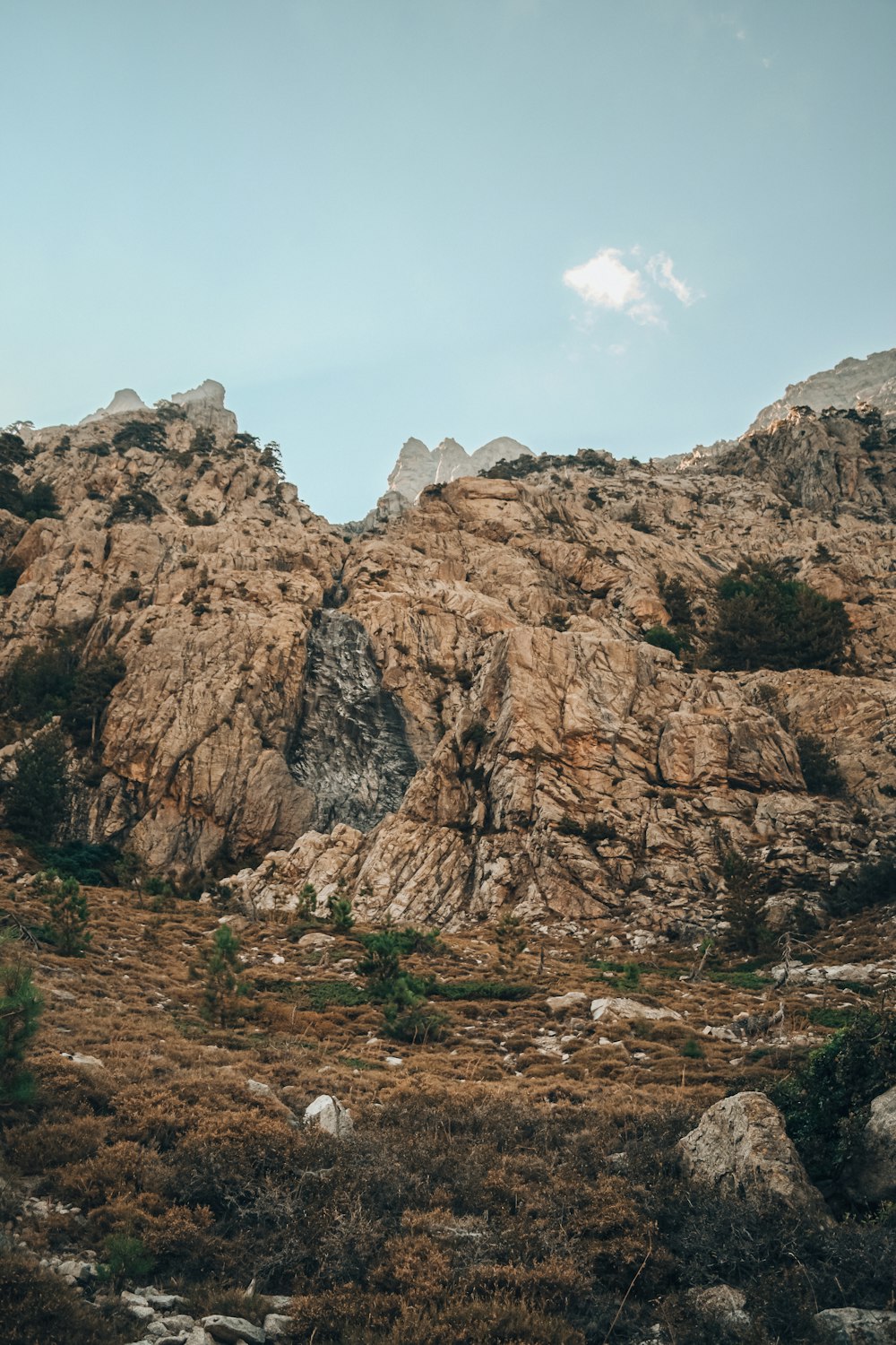 brown rocky mountain under blue sky during daytime