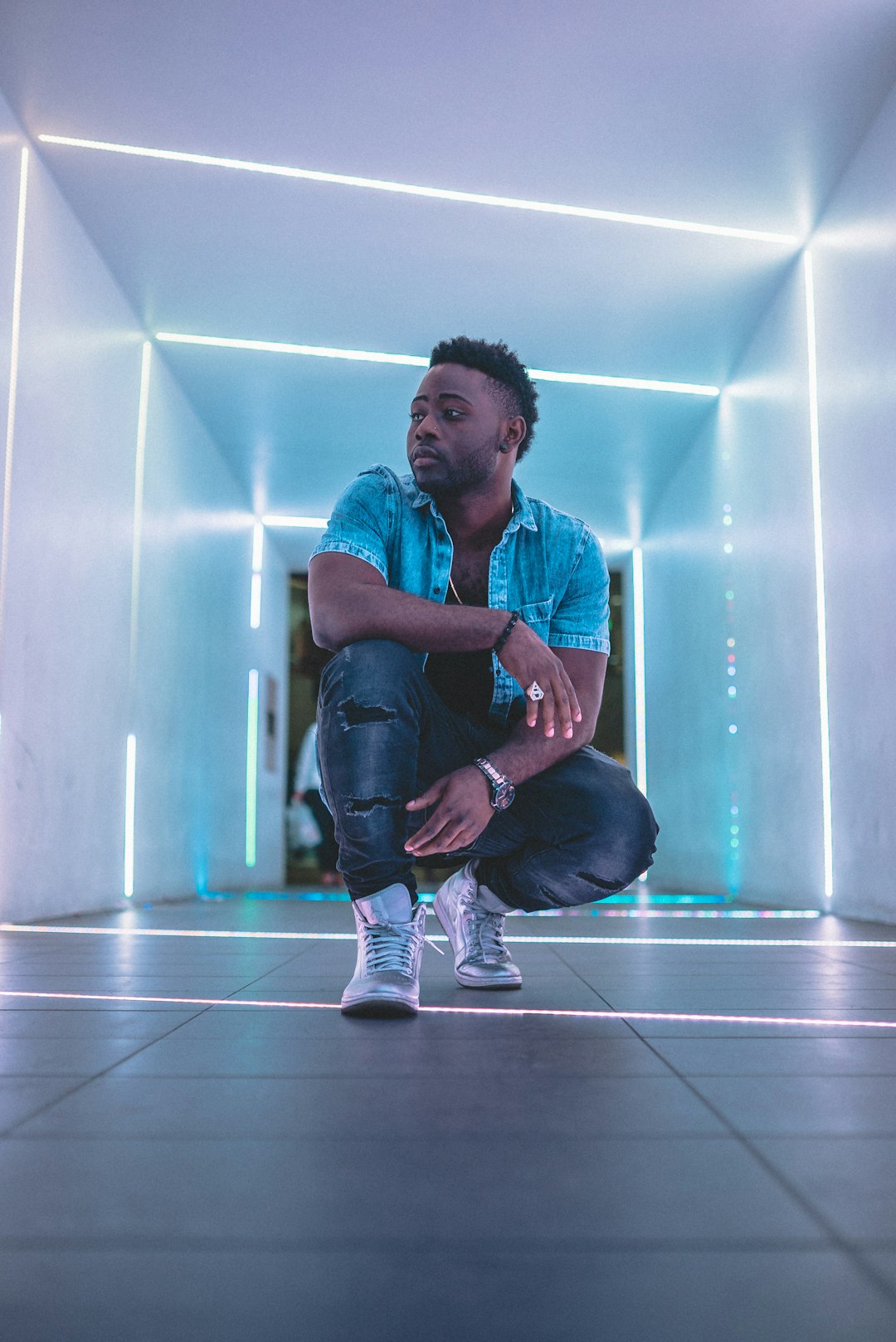 man in blue denim jeans sitting on floor