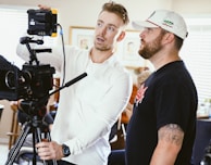 man in white dress shirt standing beside man in black crew neck t-shirt