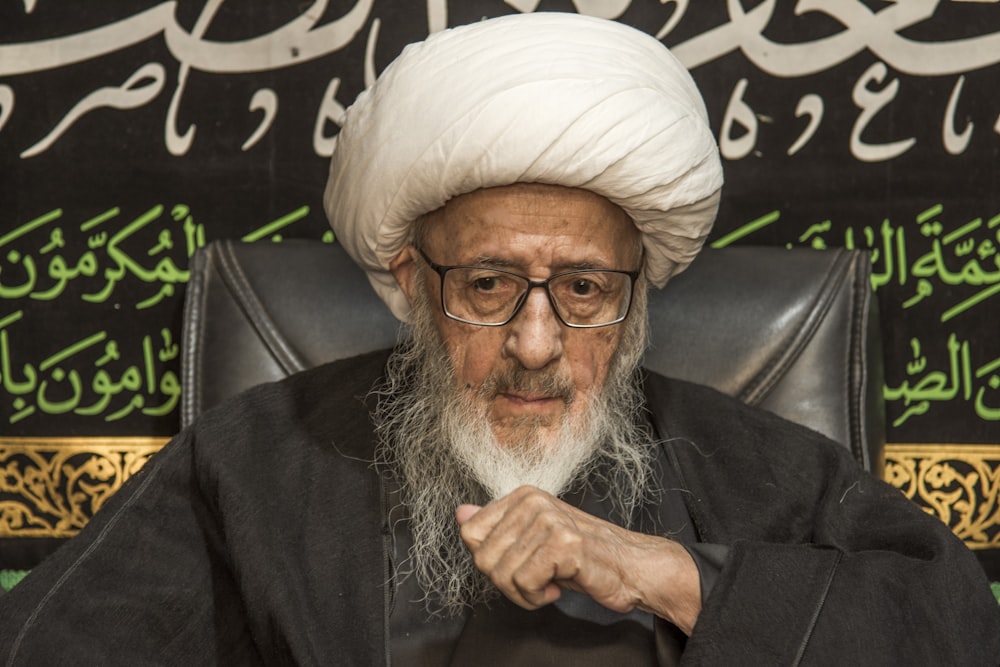 man in black suit jacket wearing white turban