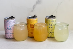 3 clear glass jars with yellow liquid