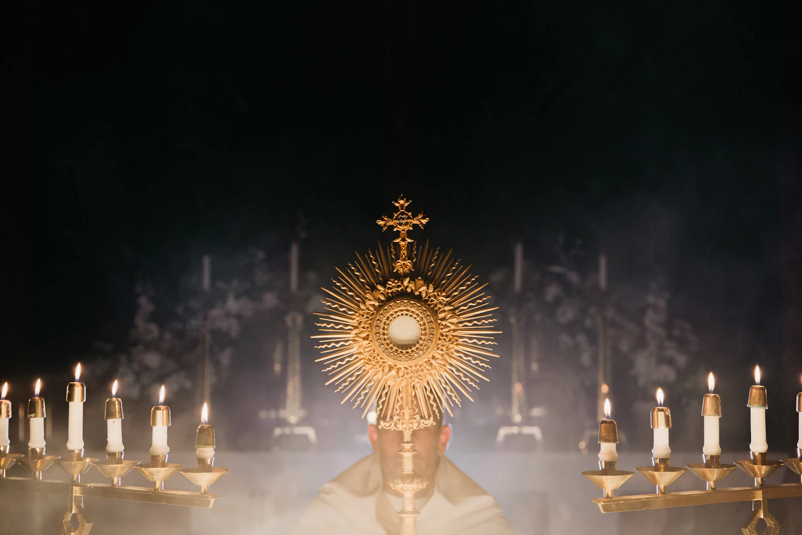 The Host in a monstrance lifted up at a Catholic conference