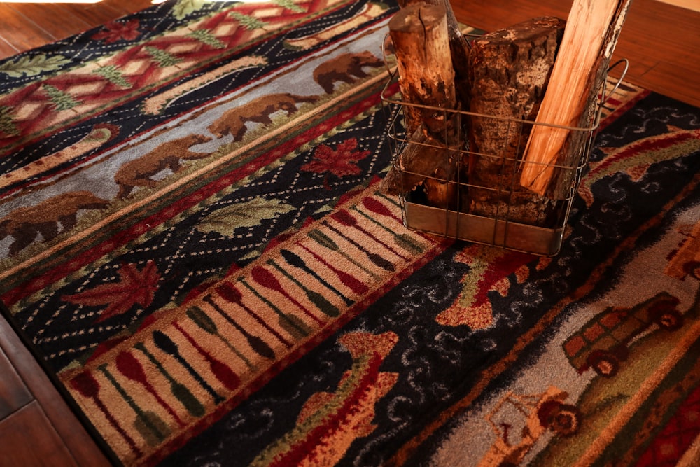 brown wooden table on red white and blue area rug