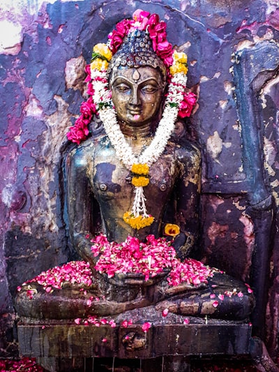 hindu deity statue with flowers
